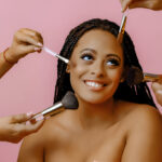 5 Common Bridal Makeup Mistakes to Avoid (And What to Do Instead) Beautiful girl looking as she is being applied make-up