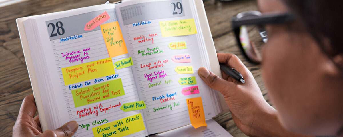Event Planning on a Budget: How I Pulled Off a Successful Event Without Breaking the Bank Businesswoman Looking At List Of Business Work In Diary With Calendar On Desk compiled by Odeya event center
