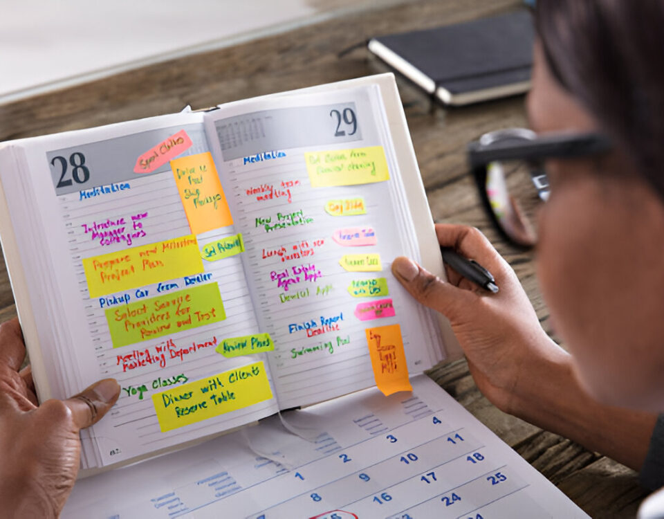 Event Planning on a Budget: How I Pulled Off a Successful Event Without Breaking the Bank Businesswoman Looking At List Of Business Work In Diary With Calendar On Desk compiled by Odeya event center